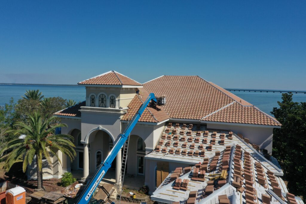 Terra Cotta roof renovation with construction crane and new tiles.